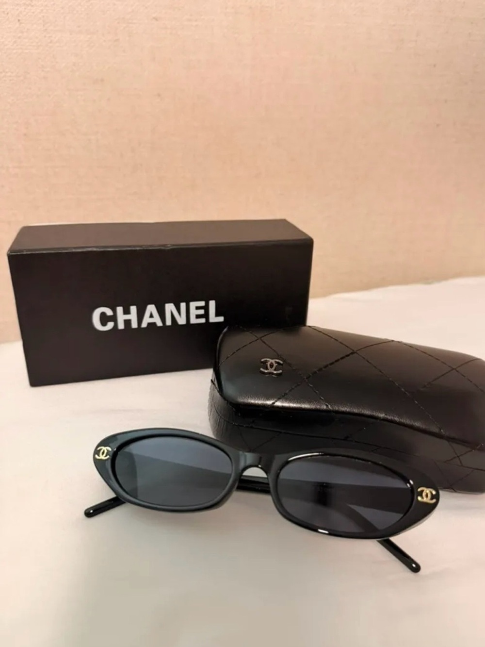 CHANEL Black Oval Sunglasses with Gold CC Emblems